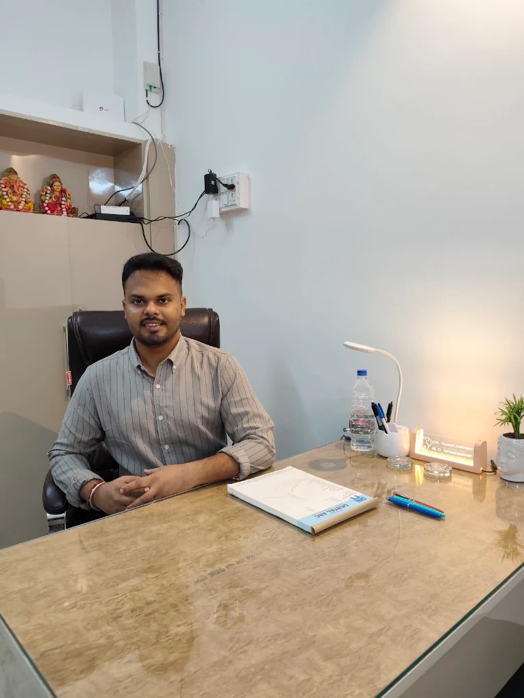Dr. Kartikey seated in his consultation room at Dental Arc